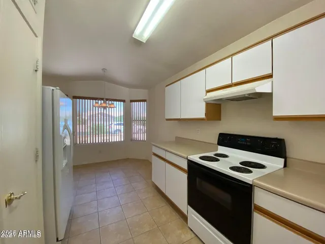 a kitchen with a stove a sink and a microwave