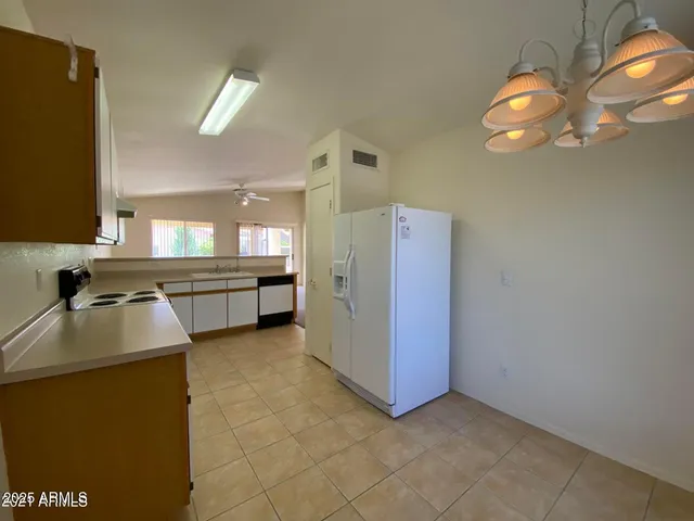 a view of a kitchen with a sink cabinet and a living room