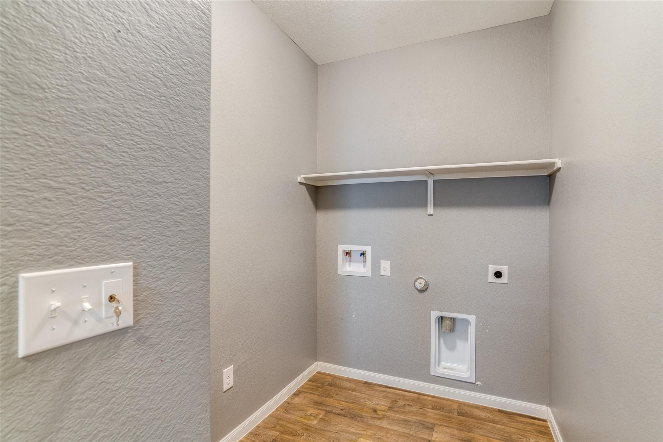 15128 Shell Bark Cove Austin, TX 78724 - Photo 21 of 25 A dedicated laundry space provides practical utility with easy hookups and convenient overhead shelving.