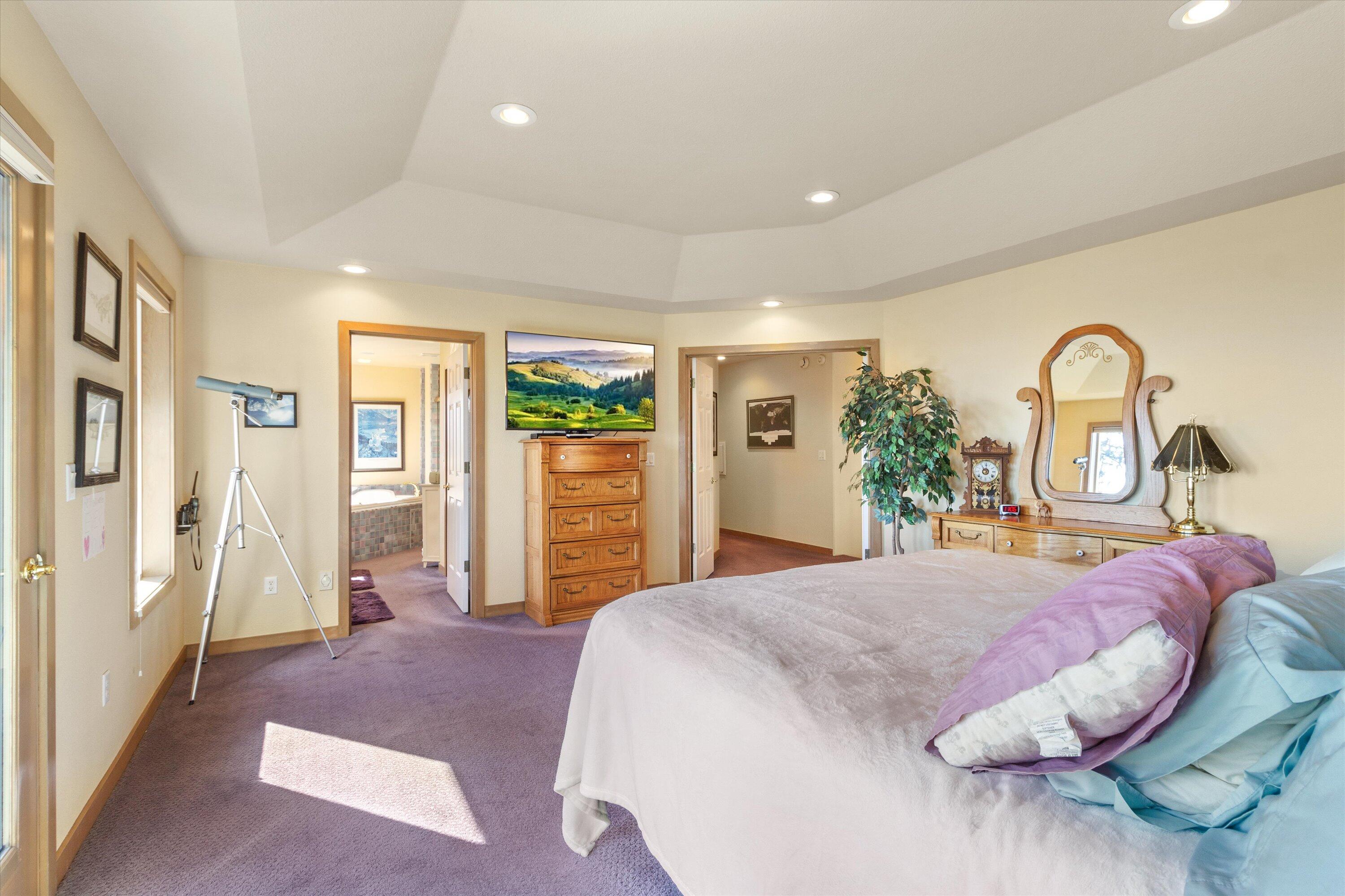 2801 Old Military Road Central Point, OR 97502 - Photo 25 of 49 a bedroom with a large bed and a chandelier
