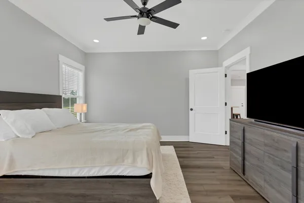 a bedroom with a bed and a flat screen tv