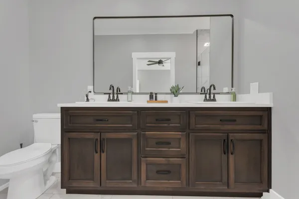 a bathroom with a sink vanity and toilet