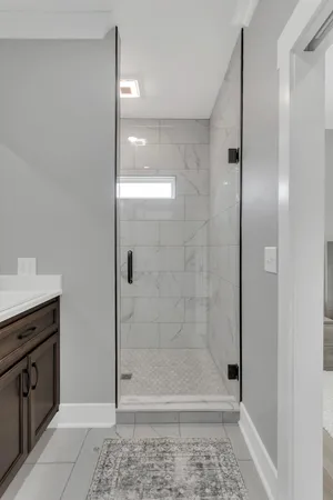 a bathroom with a shower and a sink