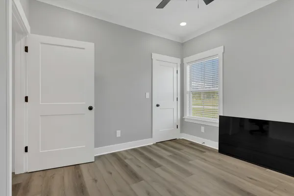 a view of empty room with wooden floor