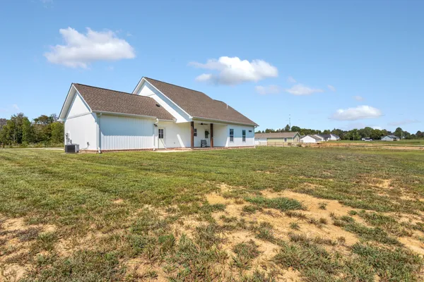 a house view with swimming pool and yard in the back