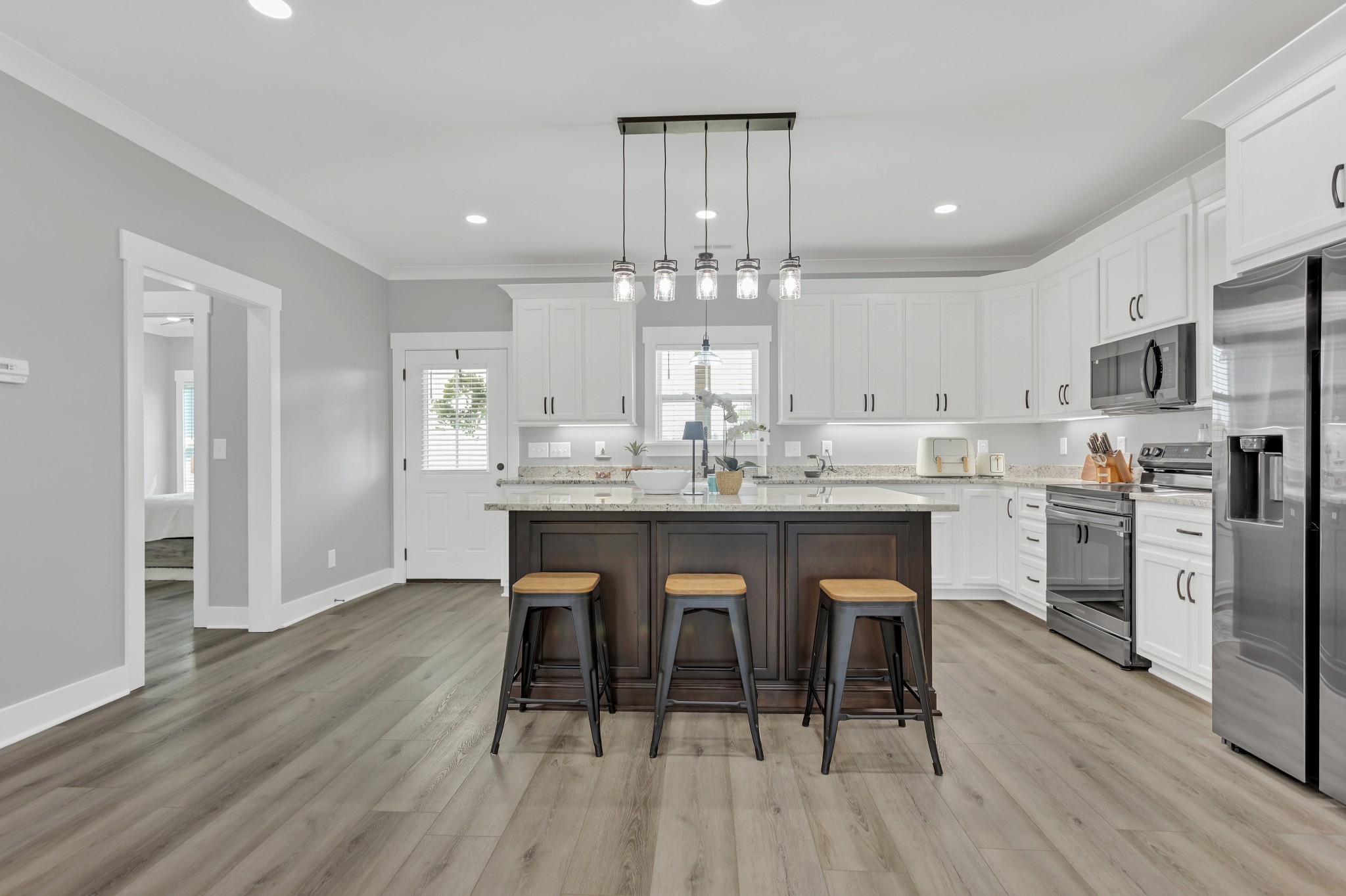 200 Beartown Road Loretto, TN 38469 - Photo 8 of 24 a kitchen with stainless steel appliances a dining table chairs stove refrigerator and cabinets