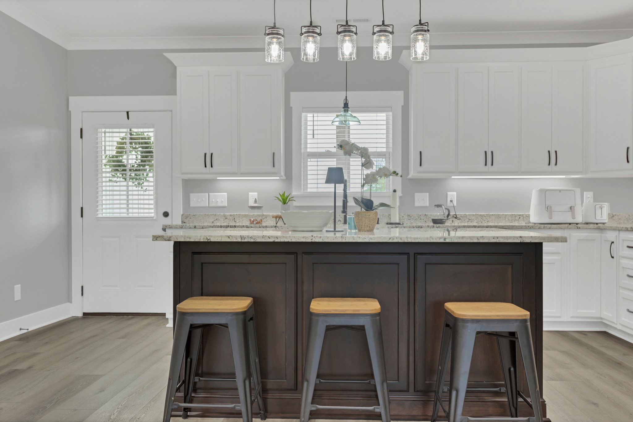 200 Beartown Road Loretto, TN 38469 - Photo 9 of 24 a kitchen with stainless steel appliances a dining table chairs and white cabinets