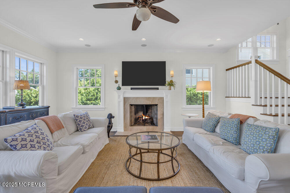 420 Tuttle Avenue Spring Lake, NJ 07762 - Photo 12 of 43 a living room with furniture a flat screen tv and a fireplace