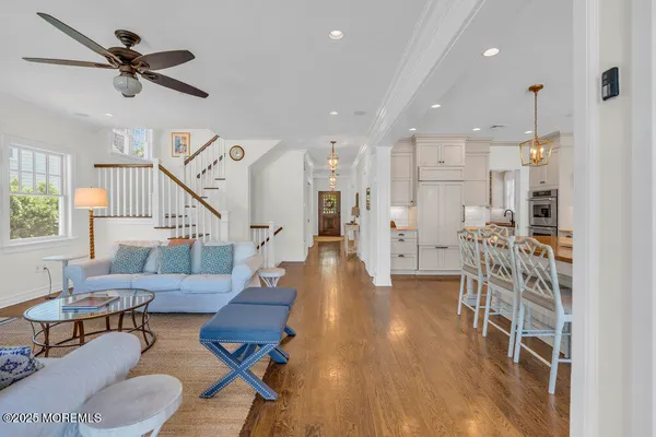 a kitchen with stainless steel appliances granite countertop a stove a sink a refrigerator a fireplace a dining table and chairs