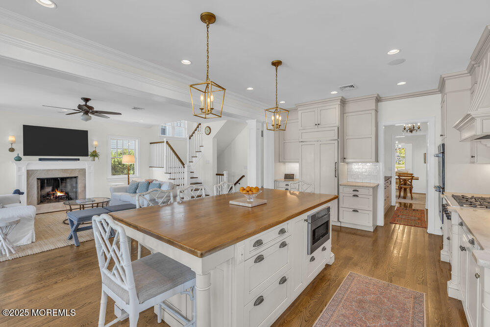 420 Tuttle Avenue Spring Lake, NJ 07762 - Photo 15 of 43 a kitchen with stainless steel appliances granite countertop a stove a sink a refrigerator a fireplace a dining table and chairs