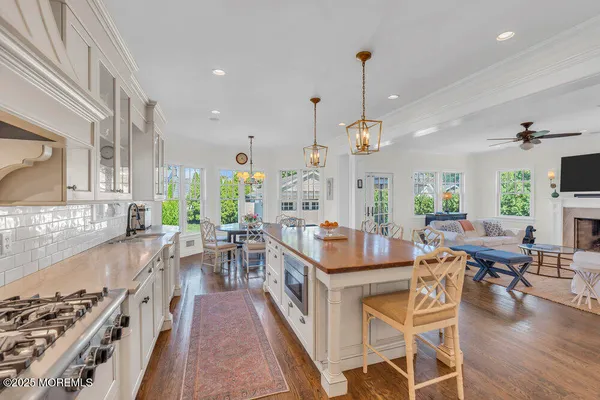 a living room with furniture a fireplace and a chandelier