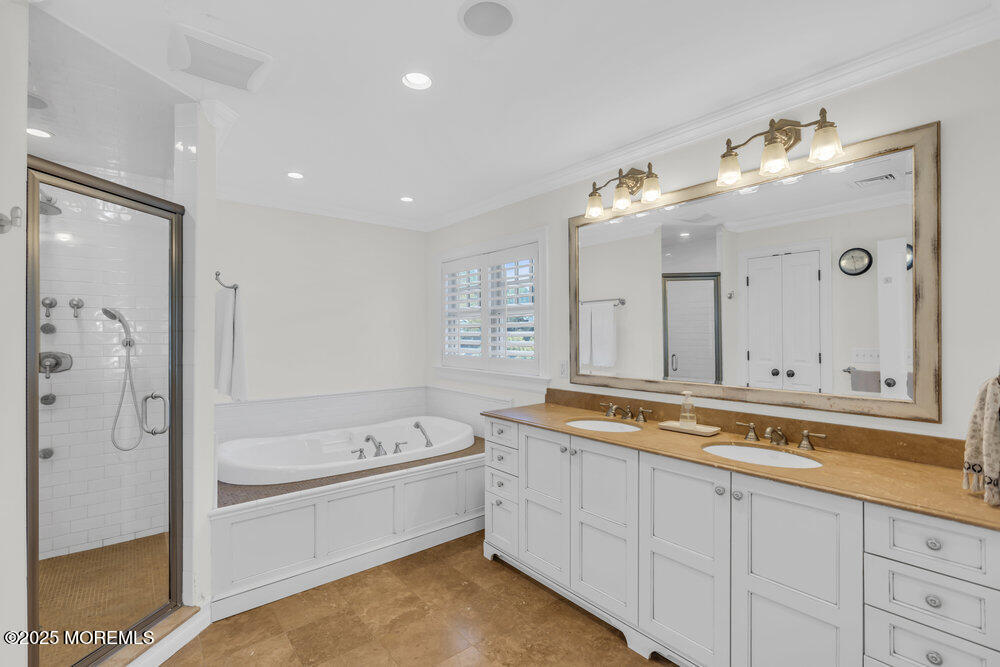 420 Tuttle Avenue Spring Lake, NJ 07762 - Photo 24 of 43 a spacious bathroom with a tub sink and mirror