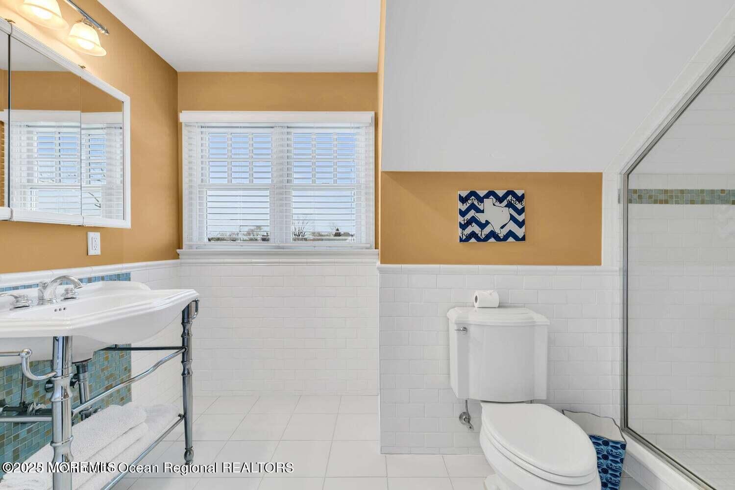 420 Tuttle Avenue Spring Lake, NJ 07762 - Photo 35 of 43 a bathroom with a toilet a sink and a large mirror