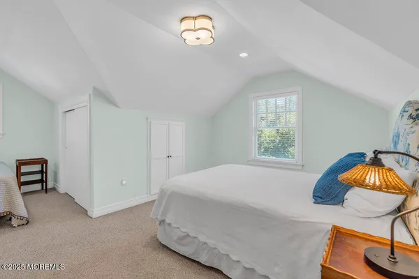 a front view of a house with a garden and plants