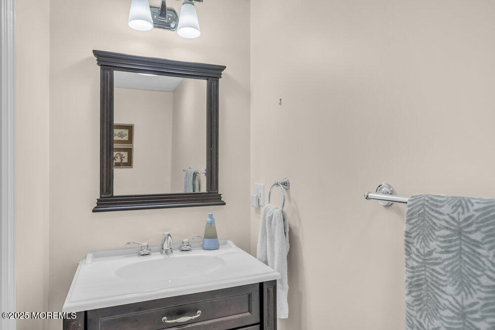 420 Tuttle Avenue Spring Lake, NJ 07762 - Photo 38 of 43 a bathroom with a sink vanity and a mirror