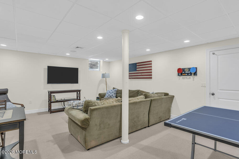 420 Tuttle Avenue Spring Lake, NJ 07762 - Photo 38 of 43 a living room with furniture and a flat screen tv