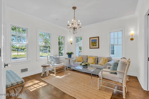 a living room with furniture and a chandelier