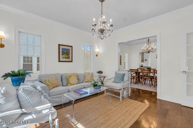 a kitchen with stainless steel appliances granite countertop a stove a sink a refrigerator a fireplace a dining table and chairs