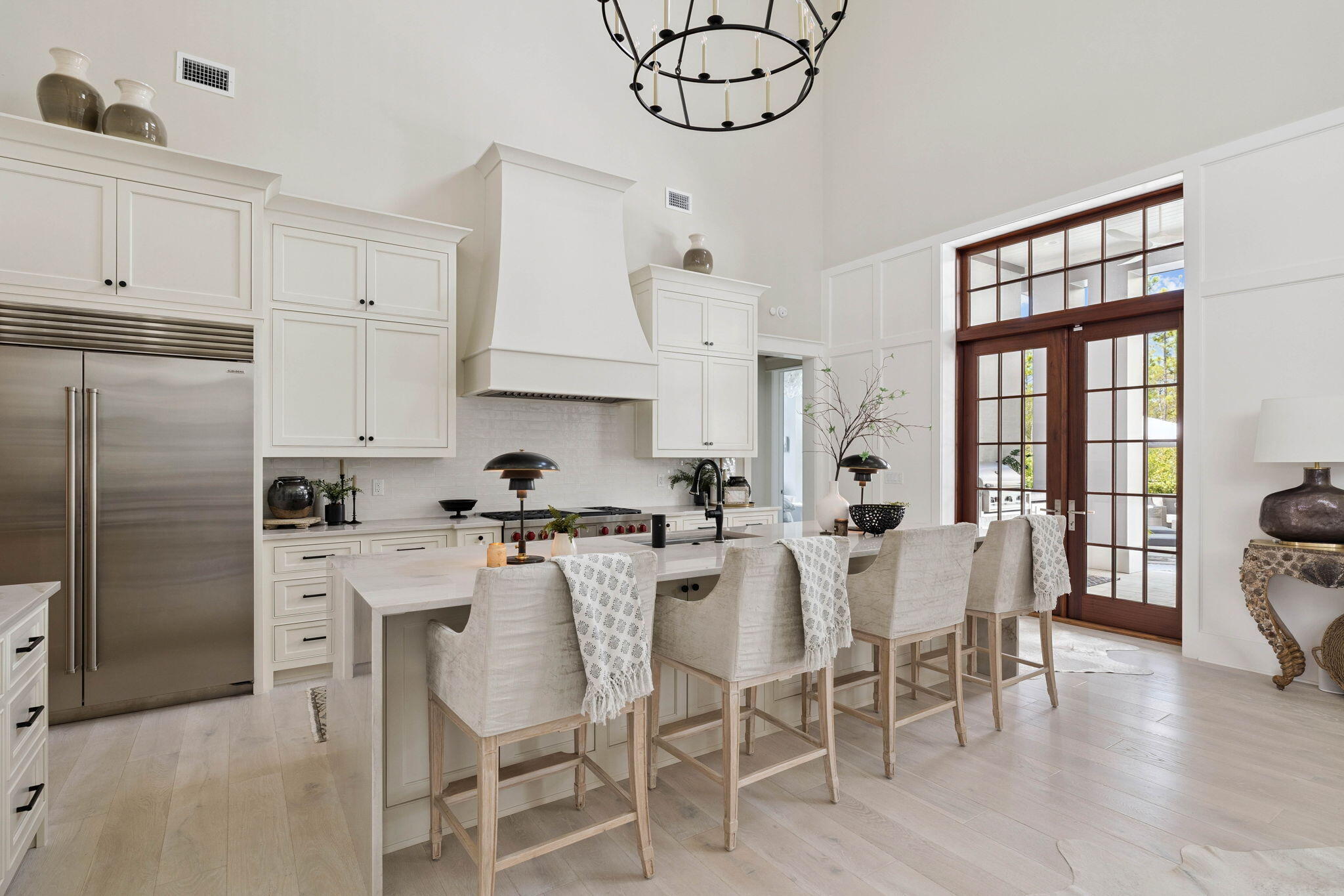 125 Golfridge Dr Inlet Beach Inlet Beach, FL 32461 - Photo 15 of 110 a kitchen with stainless steel appliances granite countertop a stove a refrigerator a white table and chairs with wooden floor