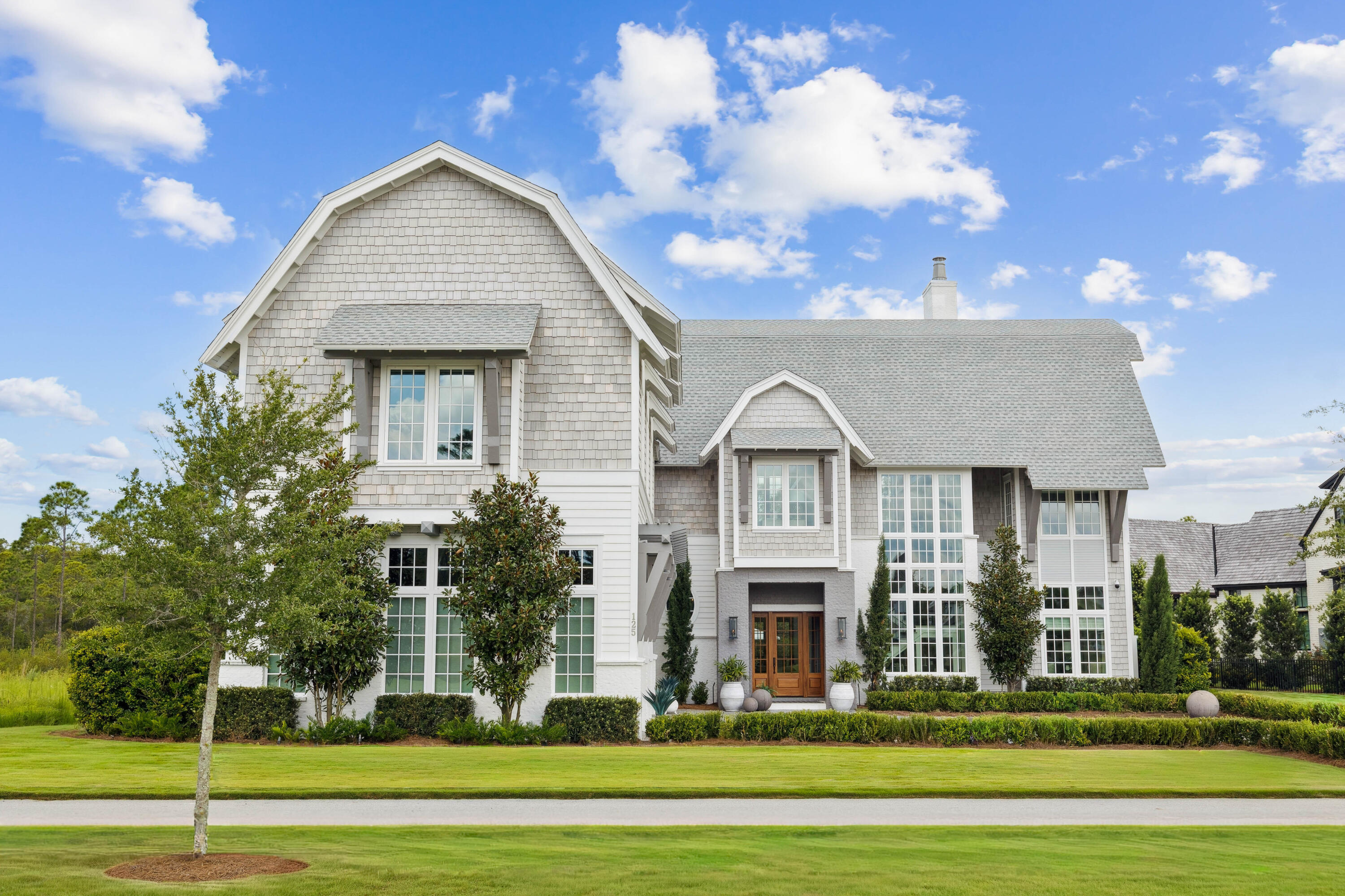 125 Golfridge Dr Inlet Beach Inlet Beach, FL 32461 - Photo 2 of 110 a view of a big house with a big yard and large trees