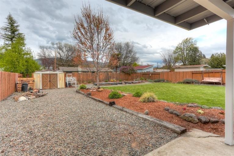 305 South Rose Street Phoenix, OR 97535 - Photo 20 of 35 Fenced backyard has huge lawn area with