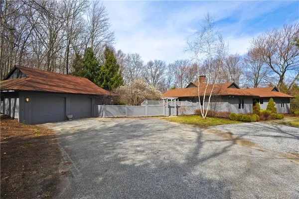 a view of a house with a yard and sitting area