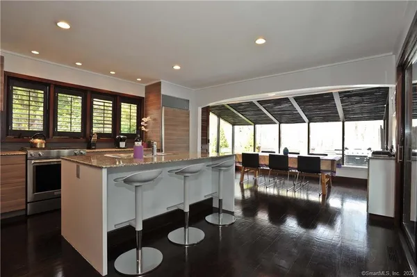 a kitchen with a large window and cabinets