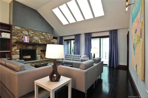 a living room with fireplace furniture and a flat screen tv