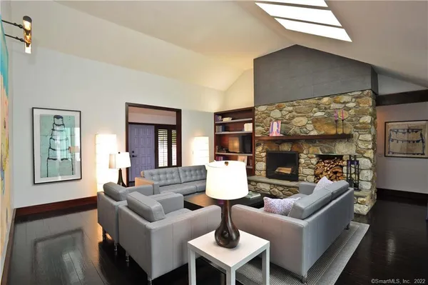 a living room with fireplace furniture and a flat screen tv