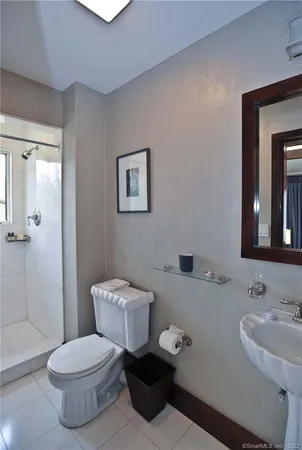 a bathroom with a toilet sink and shower