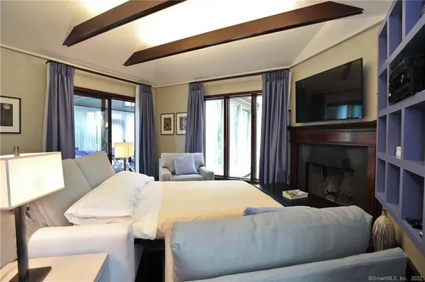 a bedroom with a bed and a television