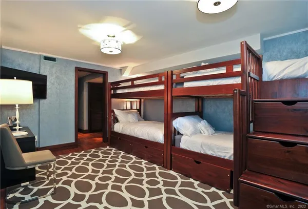 a bedroom with a bed and a chandelier