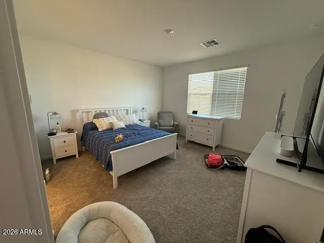 a bedroom with a bed and window