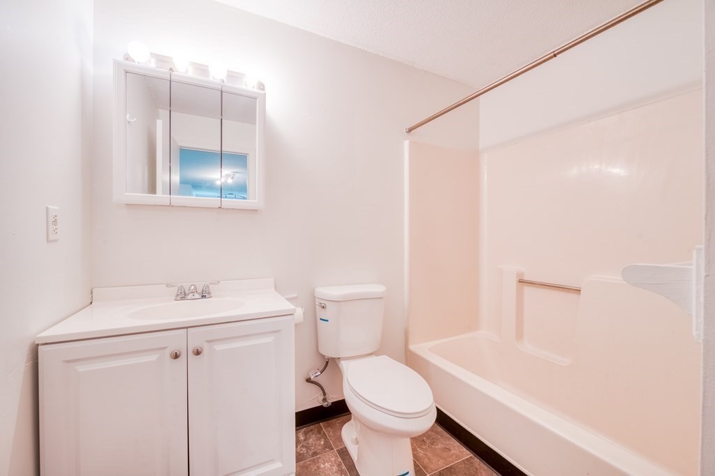 80 Stanton Street, Unit 32 Worcester, MA 01605 - Photo 13 of 21 a bathroom with a sink toilet and shower