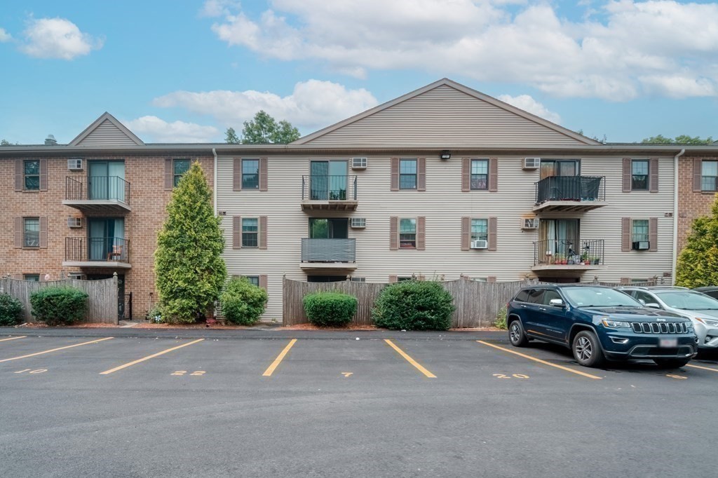 80 Stanton Street, Unit 32 Worcester, MA 01605 - Photo 20 of 21 a car parked in front of a white house