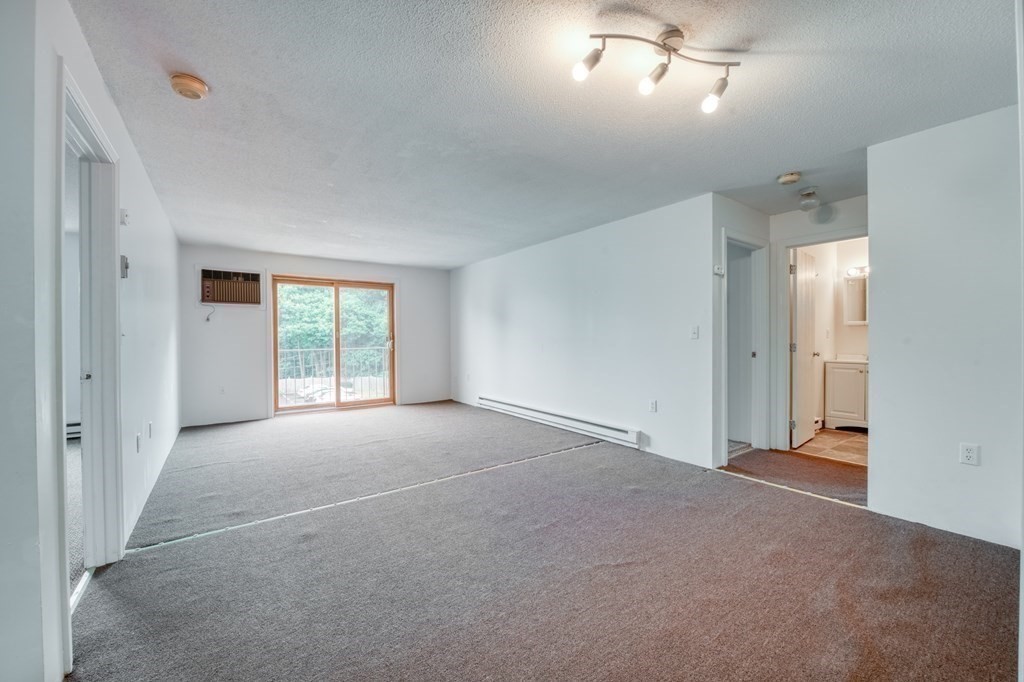 80 Stanton Street, Unit 32 Worcester, MA 01605 - Photo 6 of 21 an empty room with windows and closet