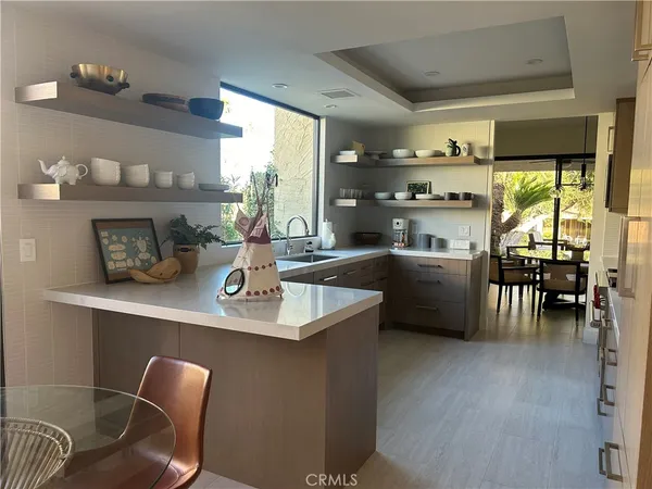 a kitchen with a table chairs and a refrigerator