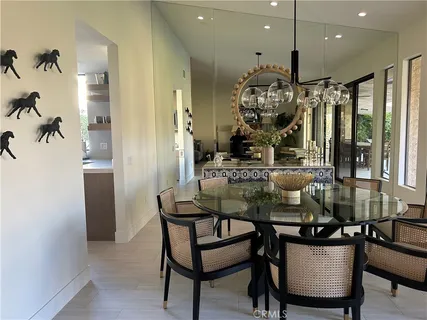 a view of a dining room with furniture and a chandelier