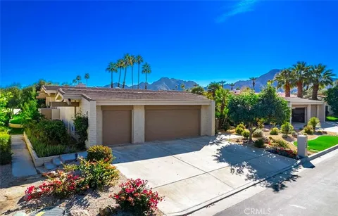 a view of a patio with table and chairs and potted plants