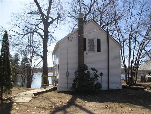 47 Pequot Point Road Westfield, MA 01085 - Photo 1 of 8 a view of a house with a yard covered in snow