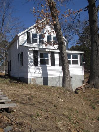 47 Pequot Point Road Westfield, MA 01085 - Photo 5 of 8 a front view of a house with a yard