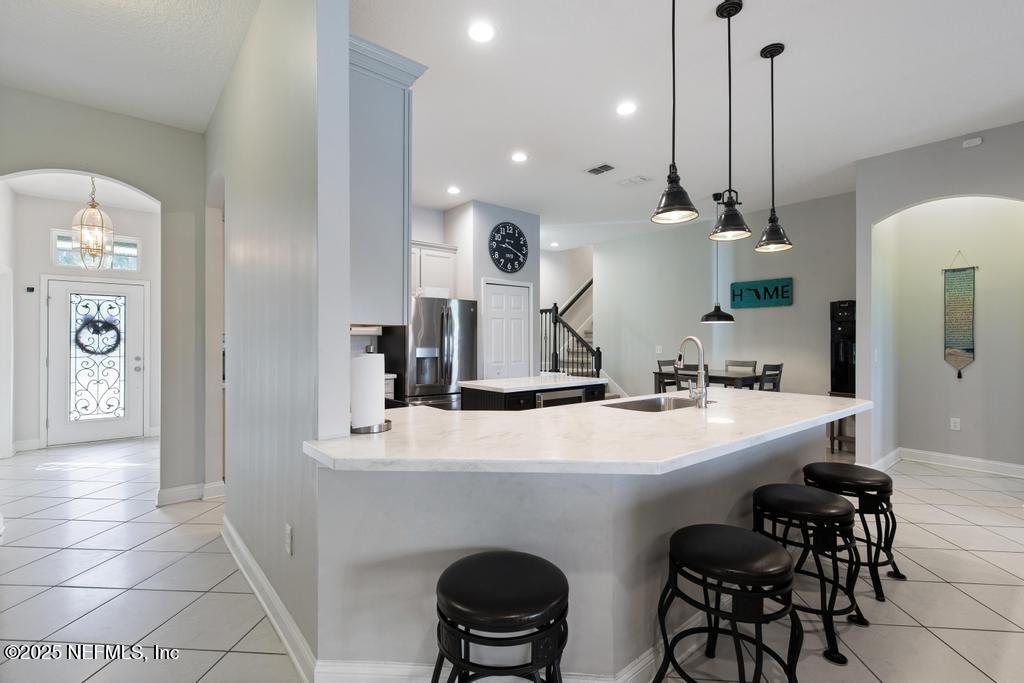 10944 Lothmore Road Jacksonville, FL 32221 - Photo 26 of 85 a kitchen with stainless steel appliances kitchen island a table and chairs in it