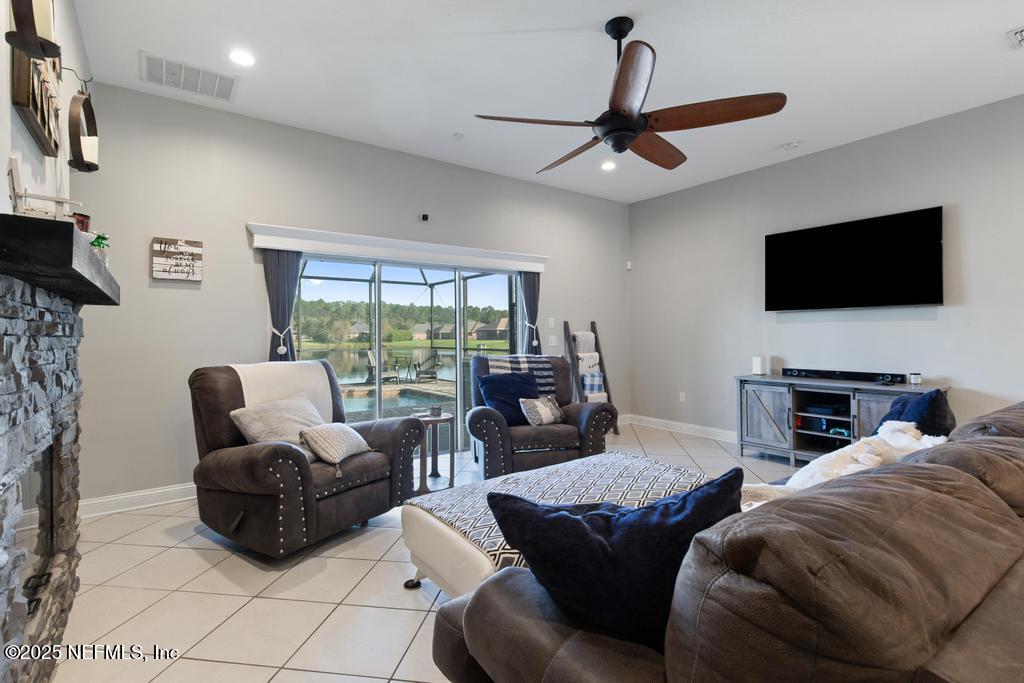 10944 Lothmore Road Jacksonville, FL 32221 - Photo 30 of 85 a living room with furniture a flat screen tv and a large window