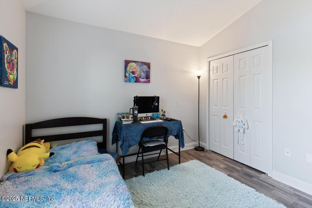 10944 Lothmore Road Jacksonville, FL 32221 - Photo 34 of 85 a bedroom with a bed and a window