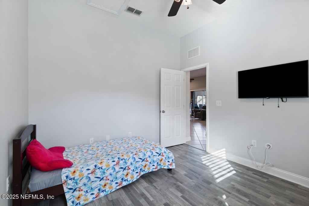 10944 Lothmore Road Jacksonville, FL 32221 - Photo 38 of 85 a bedroom with a bed and a flat screen tv