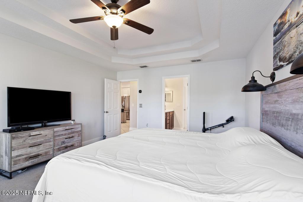 10944 Lothmore Road Jacksonville, FL 32221 - Photo 41 of 85 a bedroom with a bed and a flat screen tv