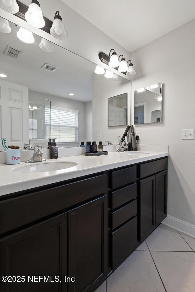 10944 Lothmore Road Jacksonville, FL 32221 - Photo 43 of 85 a bathroom with a sink vanity and mirror