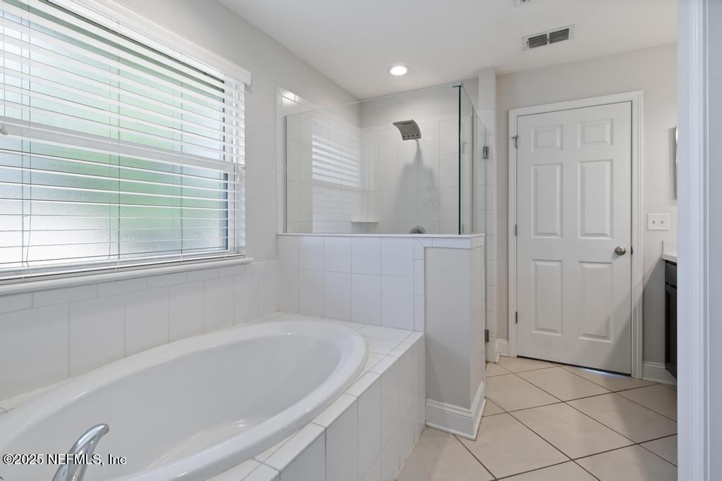 10944 Lothmore Road Jacksonville, FL 32221 - Photo 46 of 85 a bathroom with a bathtub and shower