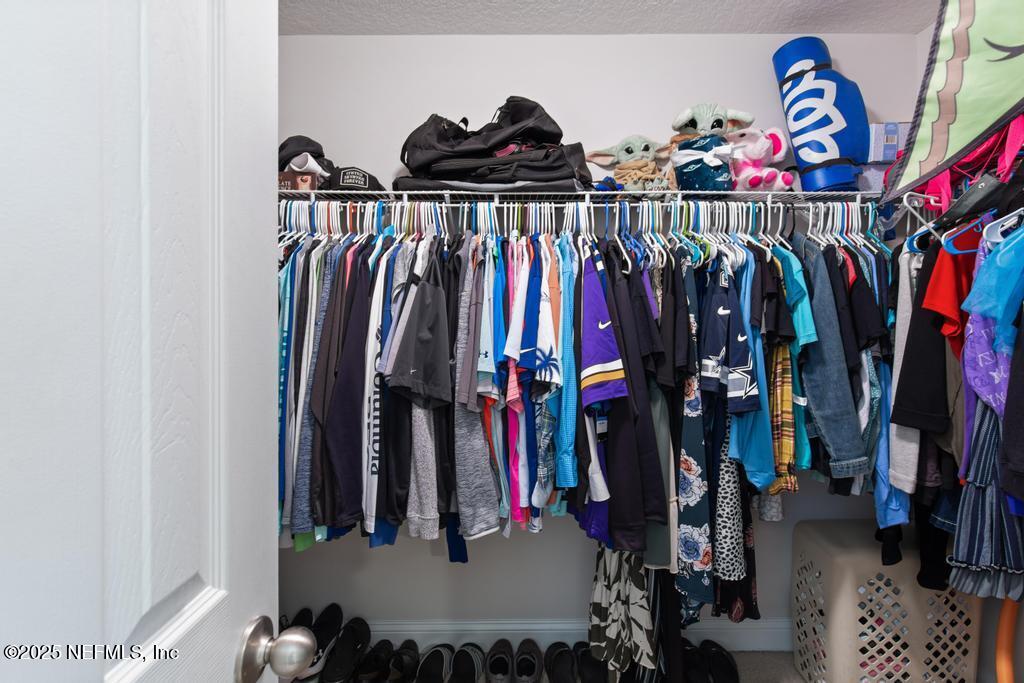10944 Lothmore Road Jacksonville, FL 32221 - Photo 47 of 85 a view of walk in closet with clothes and shoes