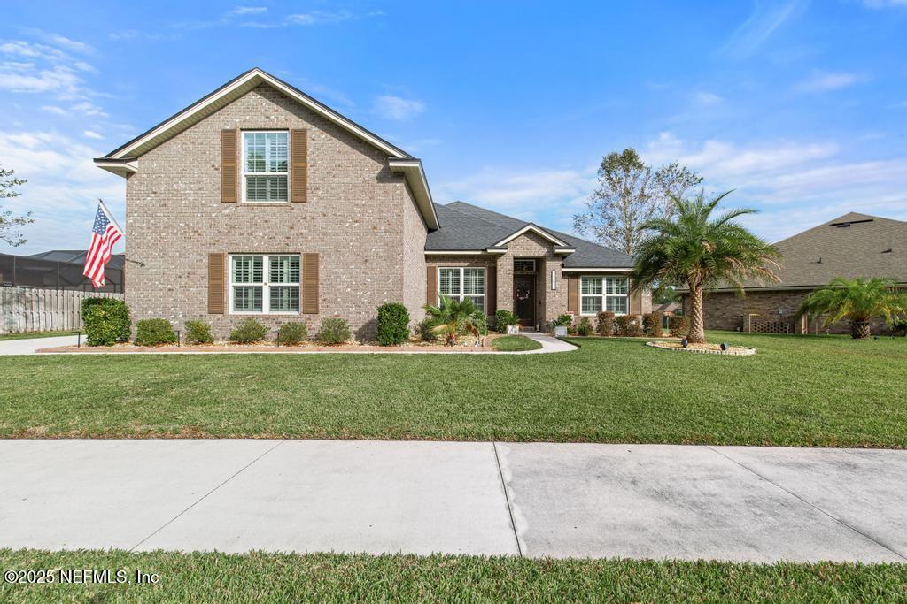 10944 Lothmore Road Jacksonville, FL 32221 - Photo 8 of 85 a front view of a house with a yard and garage